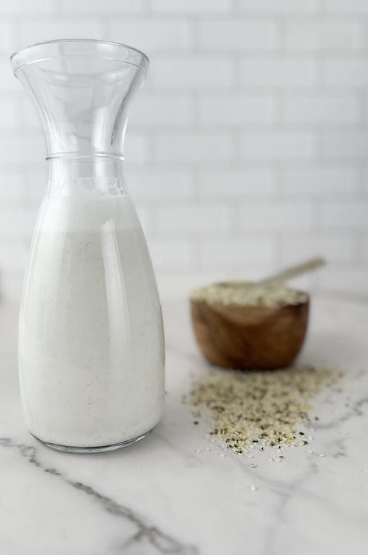 Fresh homemade hemp milk made with hemp seeds, dates, and salt served in a glass bottle